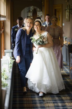 CAtherine & Bride walking in corridor